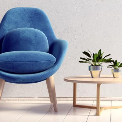 Art deco chair next to an end table with plants at Sofi Belmont Glen in Belmont, California