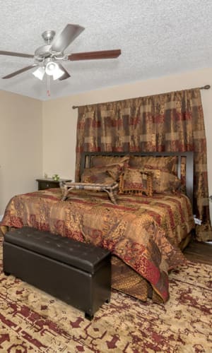 Elegant model master bedroom with a ceiling fan at Buffalo Ranch in Farmersville, Texas