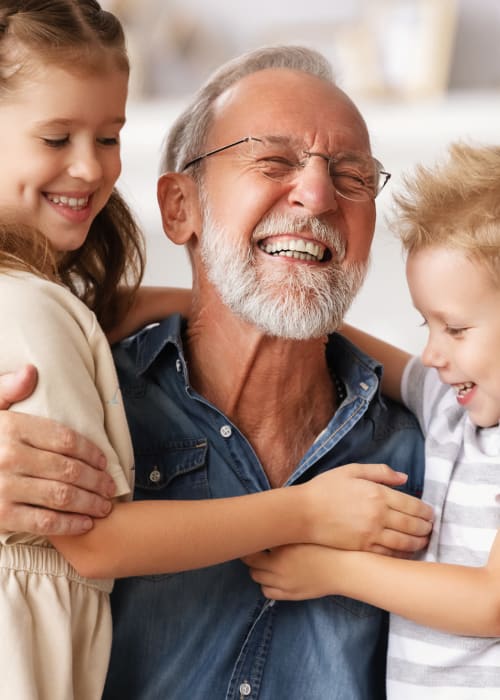 Resident holding their two grandchildren at Liberty Arms Assisted Living in Youngstown, Ohio