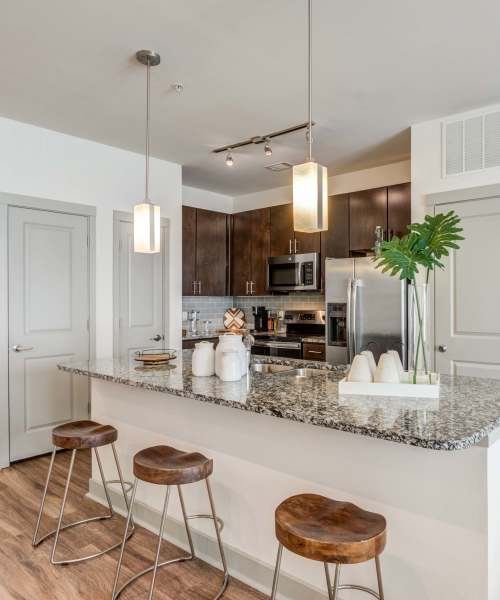 Apartment kitchen with wood-style flooring at The Carillon in Nashville, Tennessee