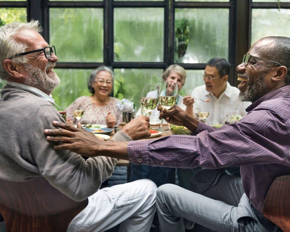 Friends chatting over dinner at Park Edge Apartments in Springfield, Massachusetts