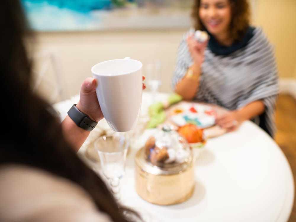 Residents enjoying a snack with their morning coffee in their new home at San Posada in Mesa, Arizona