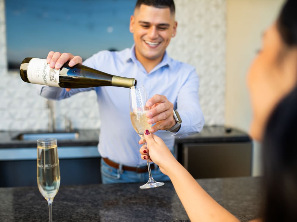 Residents enjoying the bar in the clubhouse at The Core Scottsdale in Scottsdale, Arizona