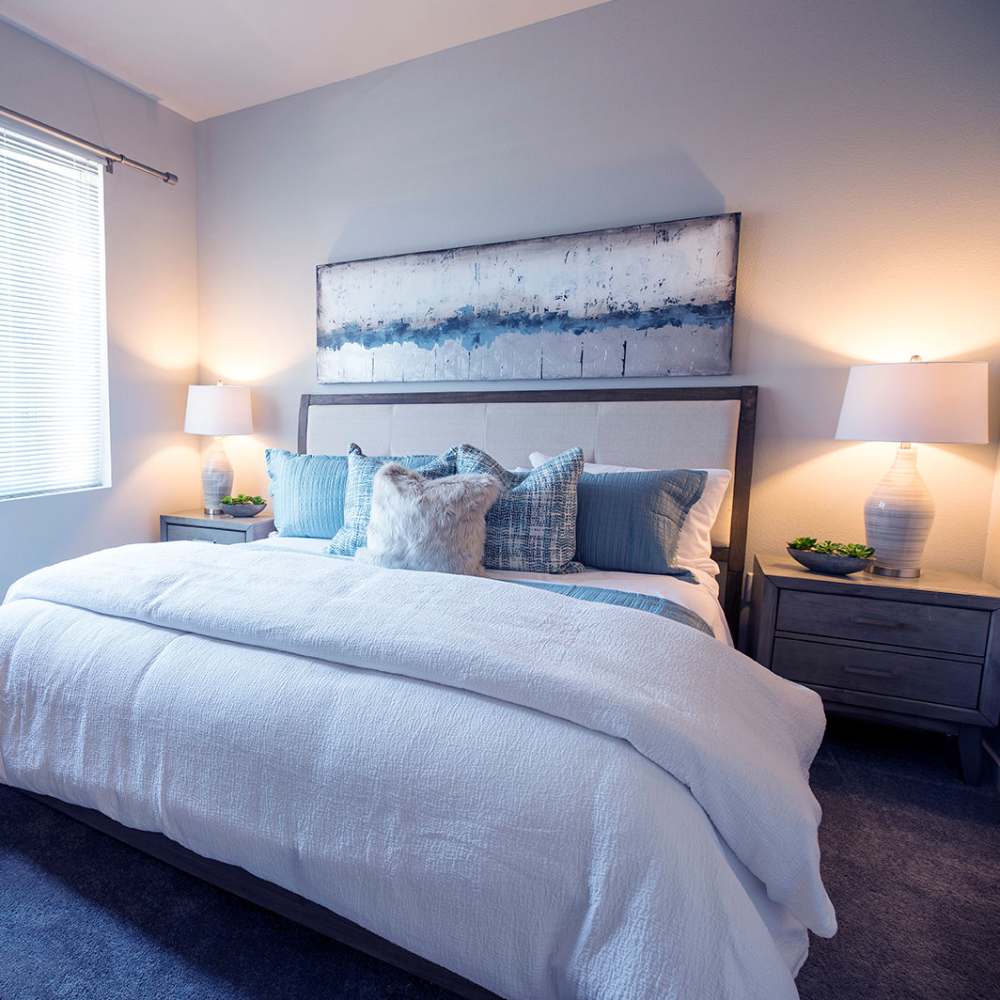 Bright bedroom with large comfortable bed at Citrine Apartments in Healdsburg, California