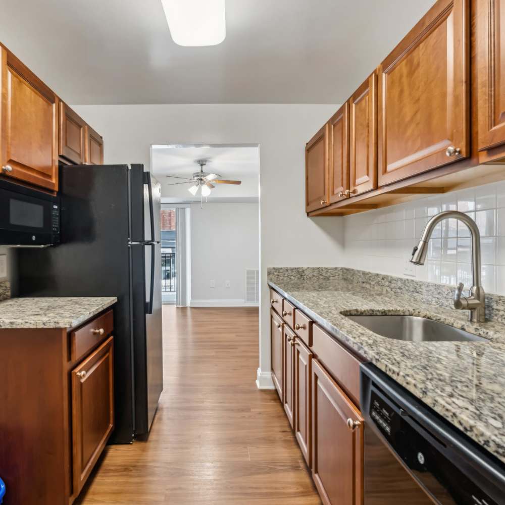 Modern kitchen with wooden cabinets and granite style counter tops at Georgia West in Silver Spring, Maryland