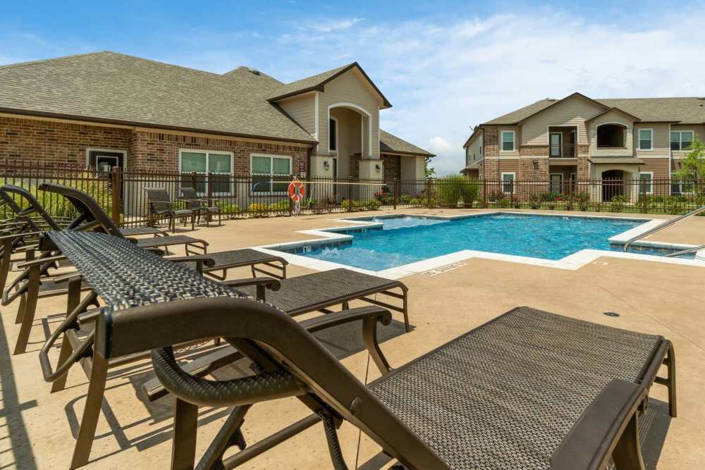 Luxurious lounge chairs beside the pool area at Pine Creek in Paris, Texas