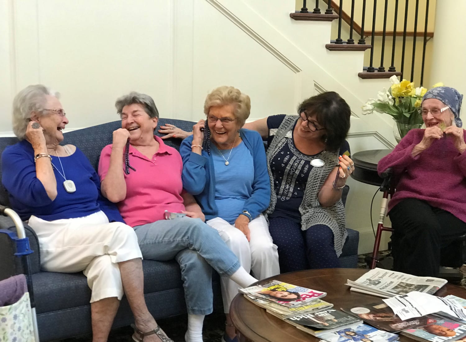 4 residents sitting on a couch laughing at The Birches at Newtown in Newtown, Pennsylvania