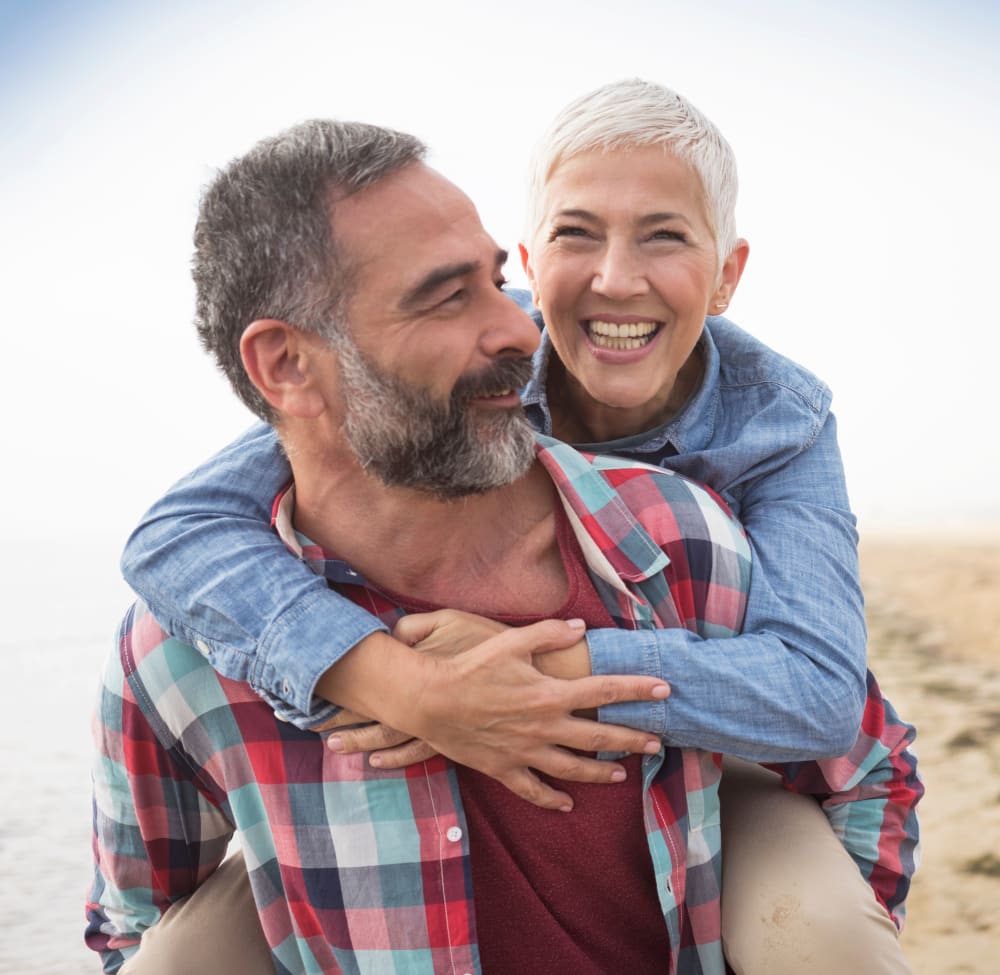 Couple walking on a beach in Hampton, New Hampshire near Olde Hampton Village Apartments