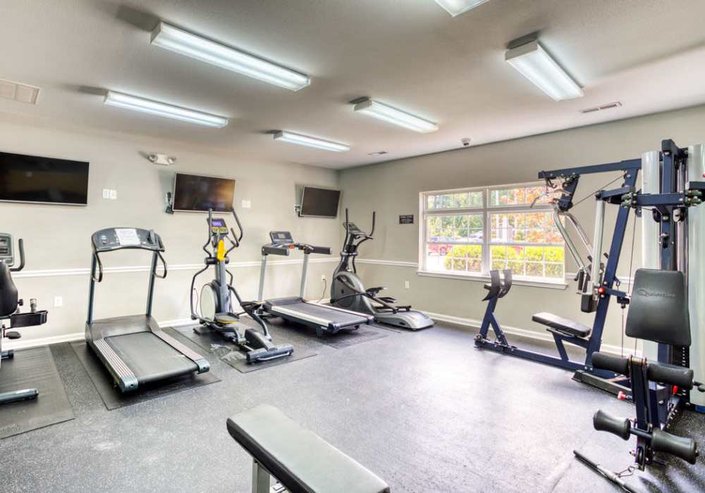 Fitness center with treadmills and weight-lifting machines and free weight stations at Eagle Point Village in Fayetteville, North Carolina