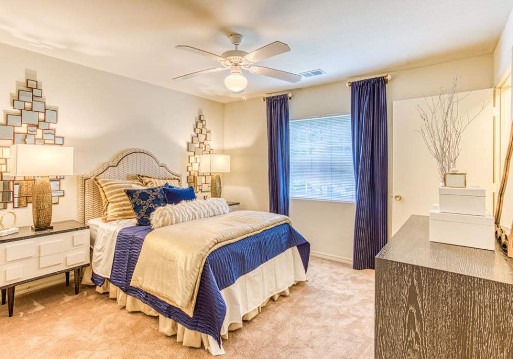 Spacious bedroom with large comfortable bed and ceiling fan at Bromley Village in Fort Mill, South Carolina