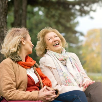 Two residents sitting on a bench talking outside at York Gardens in Edina, Minnesota