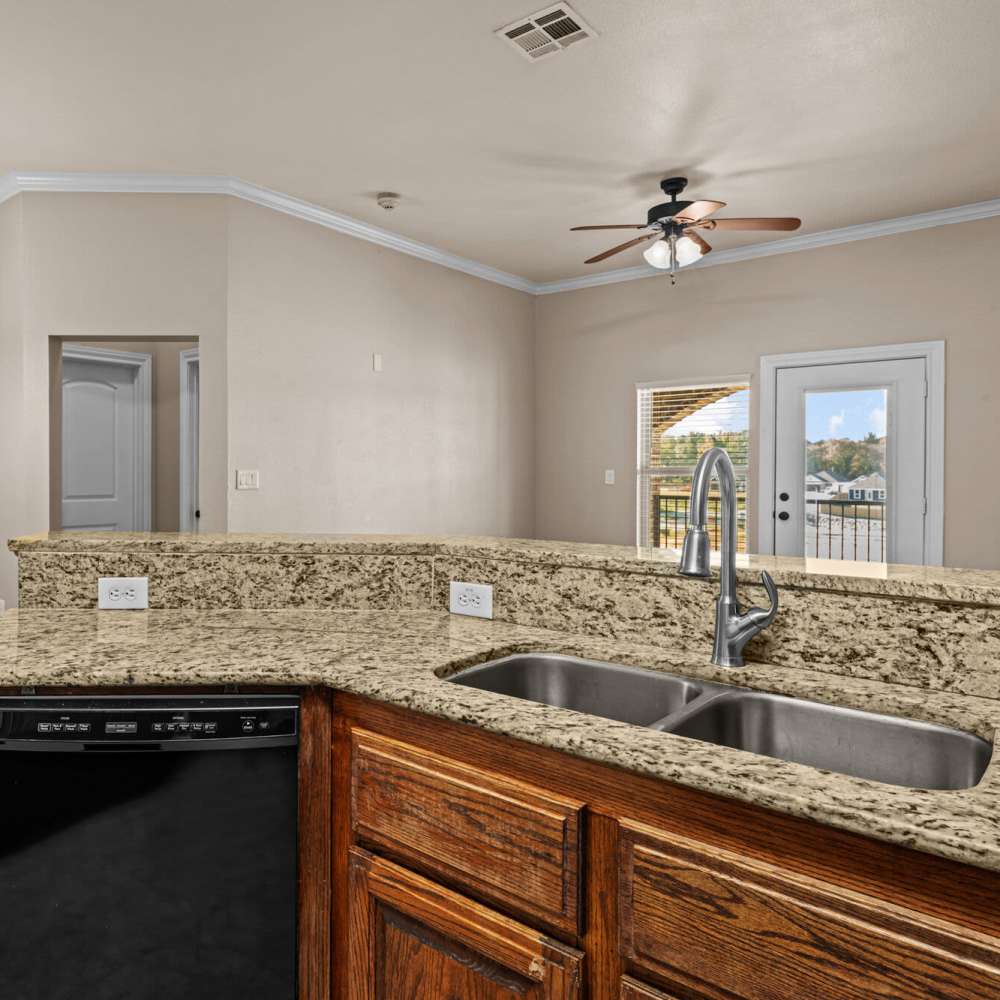 Kitchen with stainless steel sink at The Arbors of Mineola in Mineola. TX
