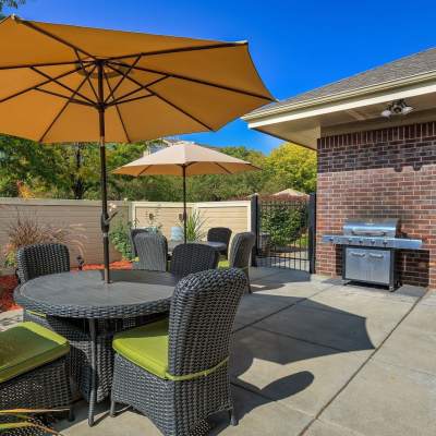 Outdoor seating with barbeque at UTE Creek Apartments in Longmont, Colorado