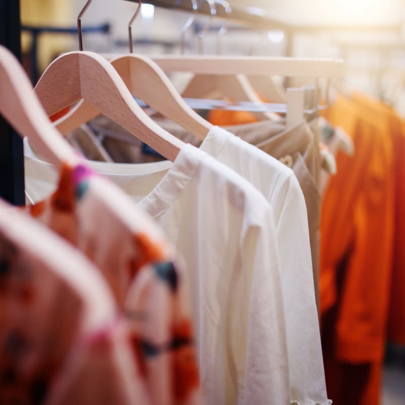 Row of women's shirts on hangers in one of the boutiques at Portside Ventura Harbor in Ventura, California