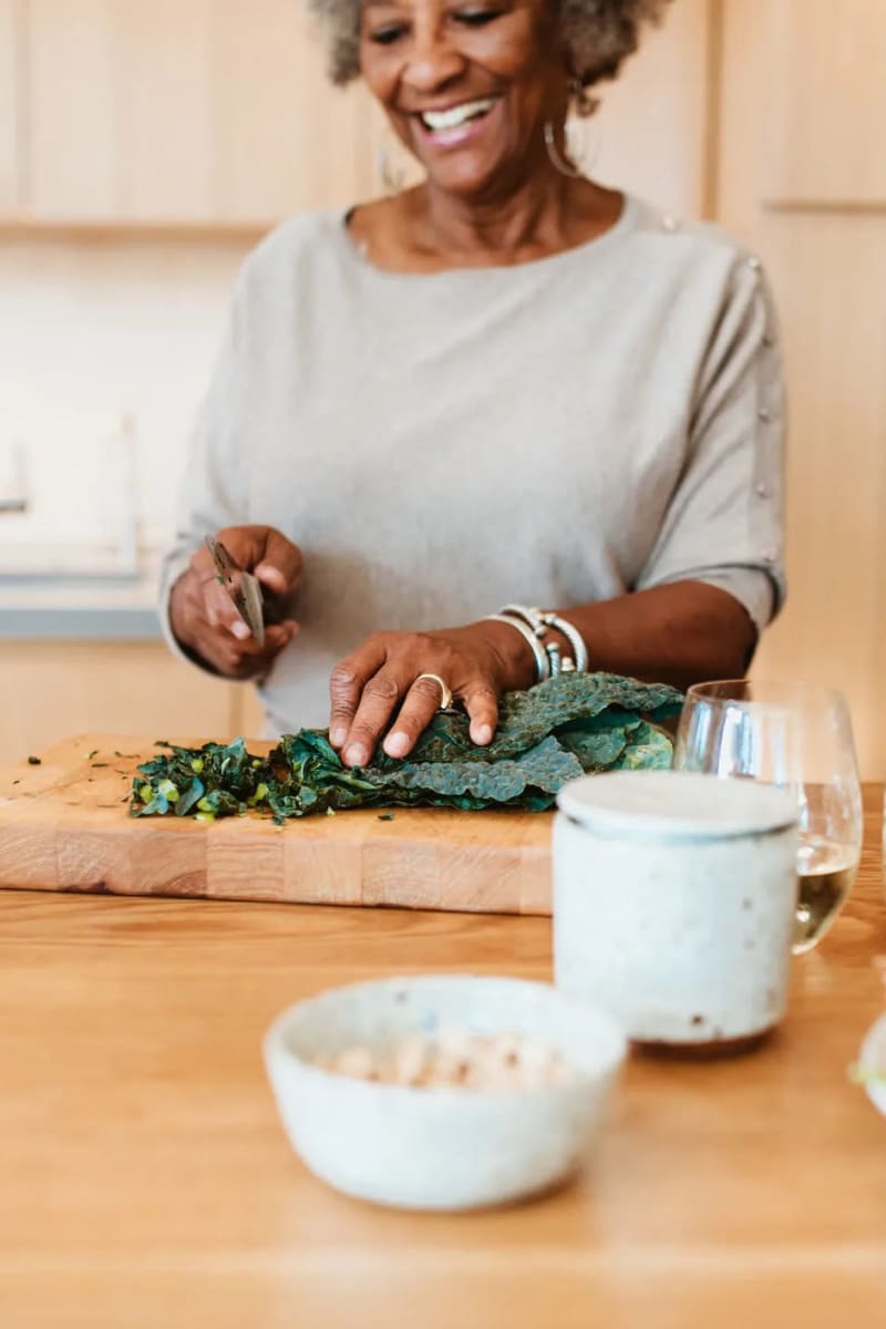 Resident chopping kale at Carriage Inn Katy in Katy, Texas
