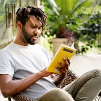 A man reading a book outside at Foundry Yards in Birmingham, Alabama