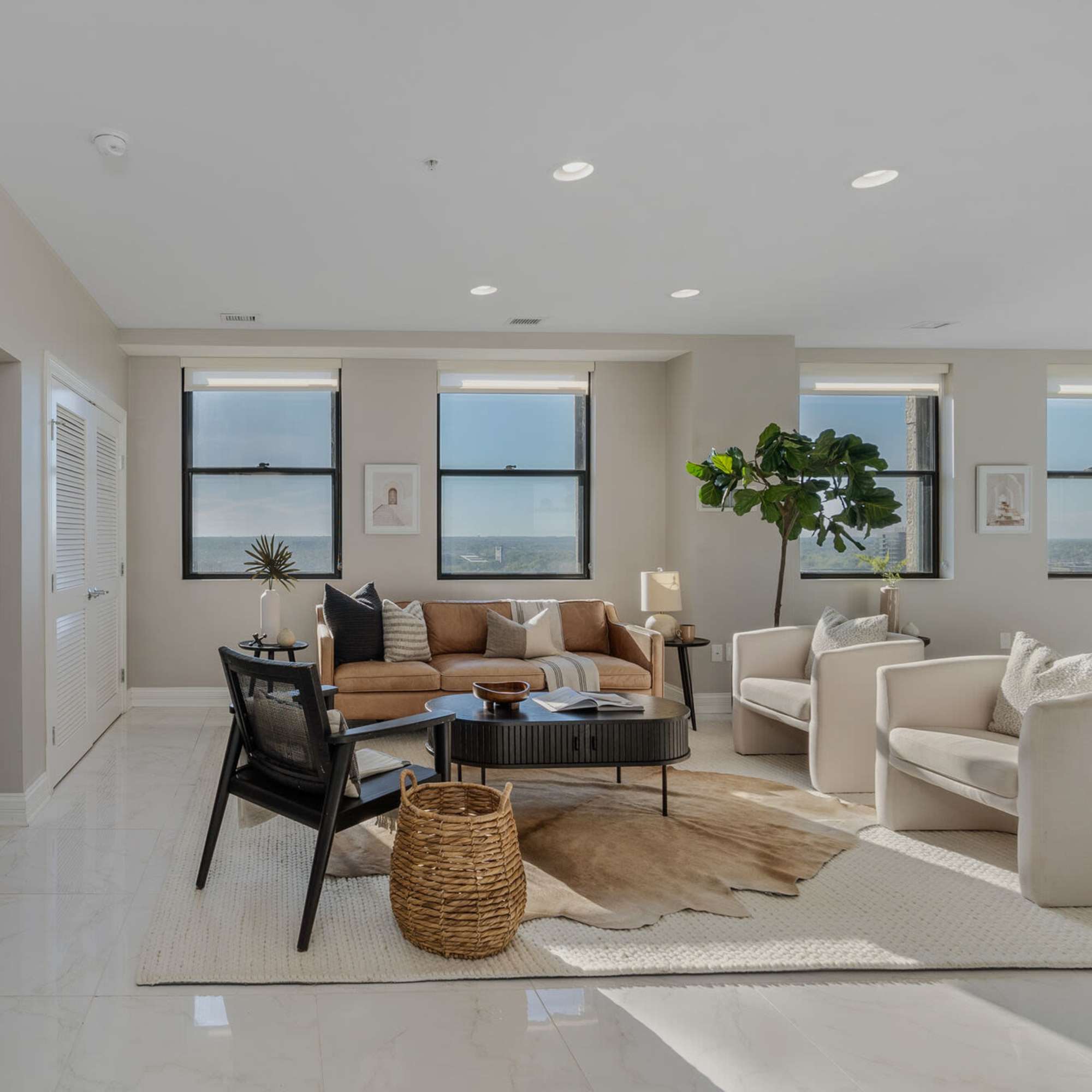Sunlit living room with modern furnishings and stylish decor at LeVeque Tower in Columbus, Ohio