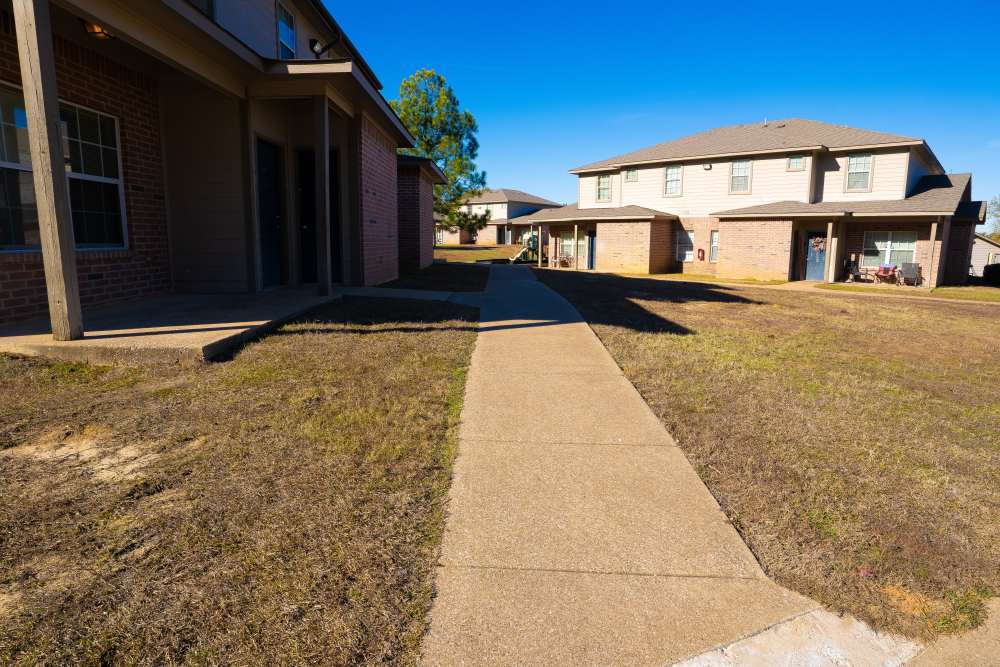 Townhomes exterior shot with pathway at Millpoint Townhomes in Henderson, Texas