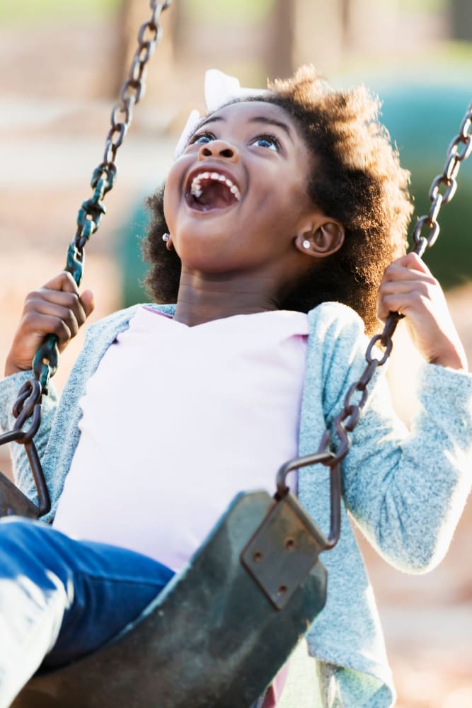 Resident swinging in the playground at Brightside at Etowah in Cartersville, Georgia