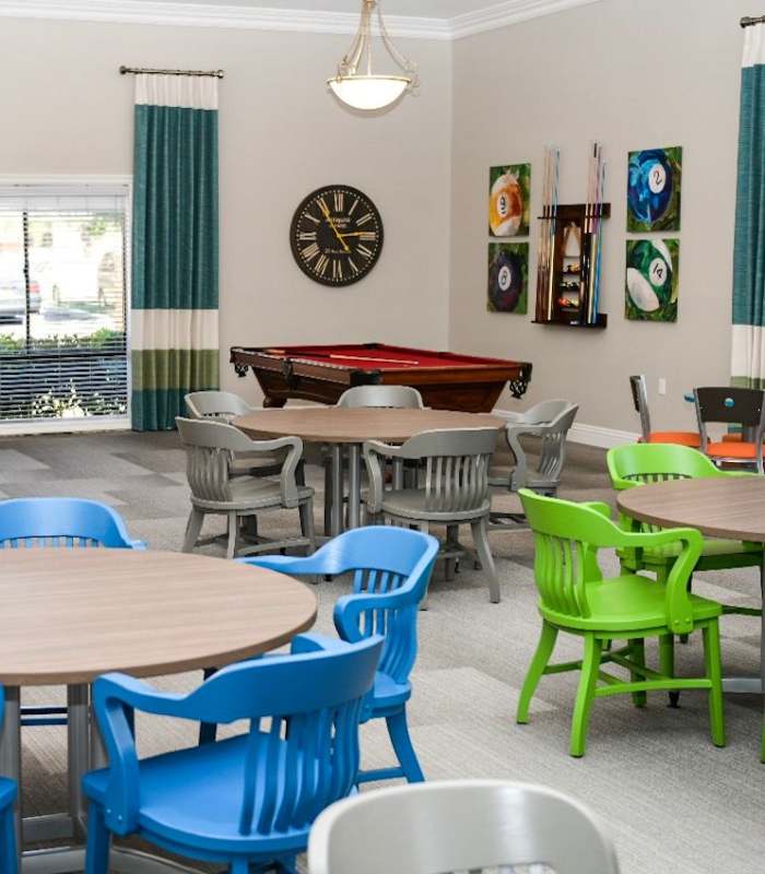 Resident clubhouse with pool game at The Villas at Rowland Heights in Rowland Heights, California