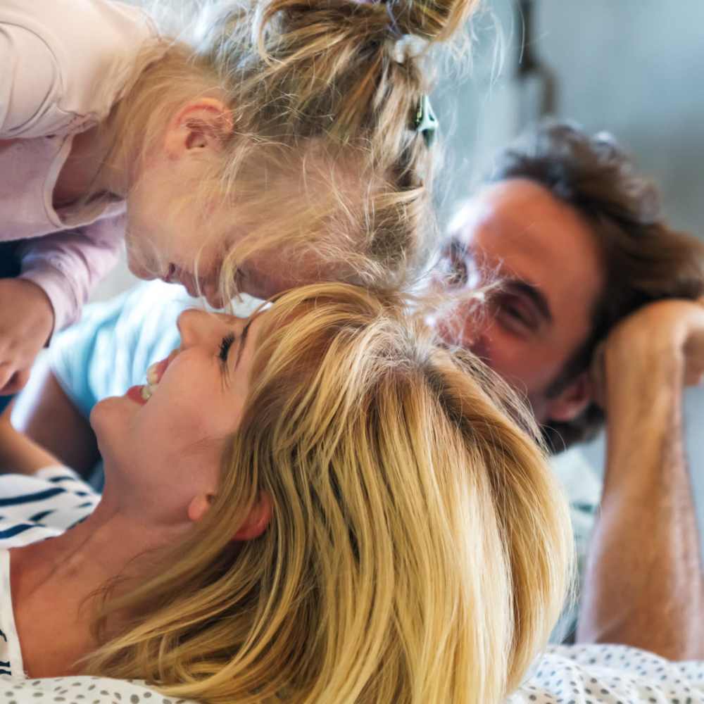 A resident family relaxing in their bedroom at The Millwright in Cornelius,North Carolina