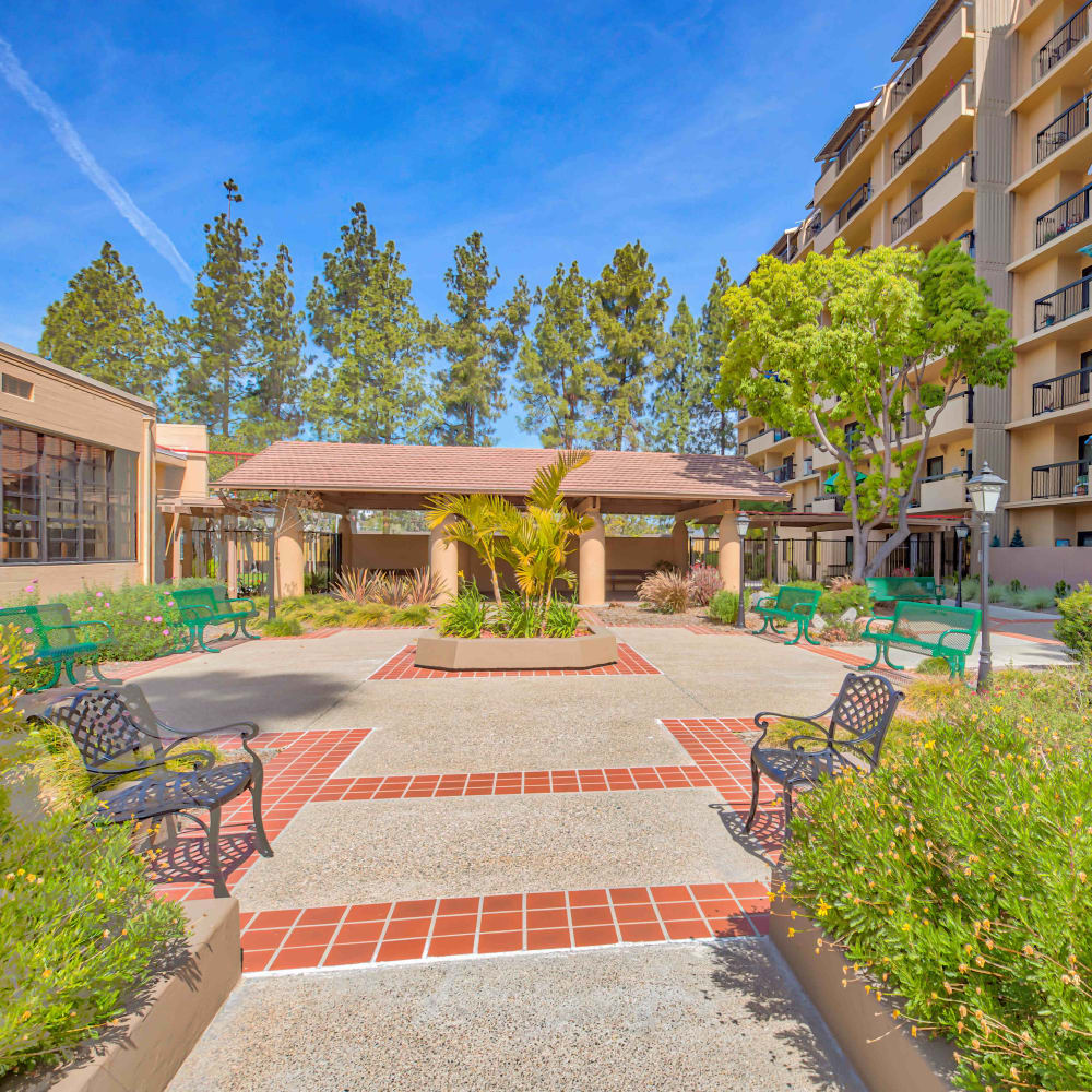 Landscaped courtyard with park benches at The Springs in La Mesa, California