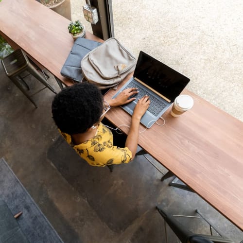 Resident on her laptop at a coffee shop near Stone Creek at Wekiva in Altamonte Springs, Florida