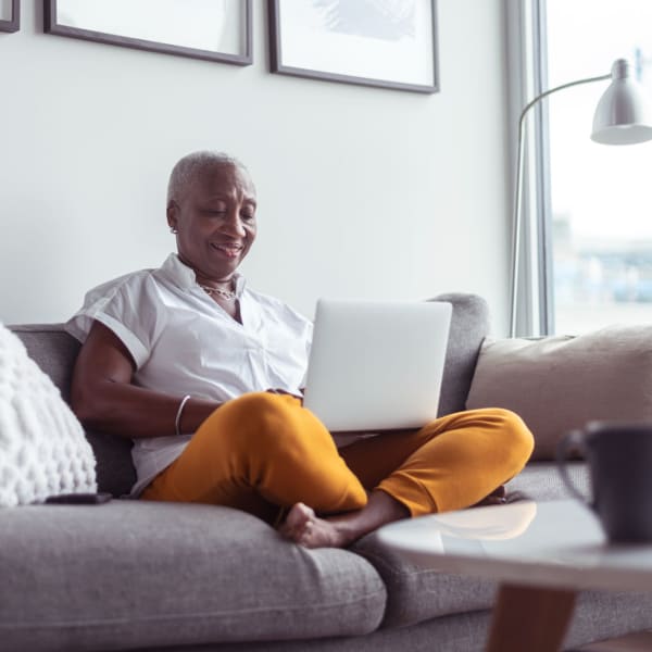 A resident works from her laptop in her apartment at The Cascades, Virginia Beach, Virginia