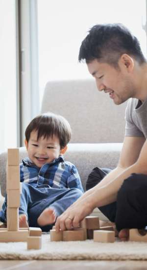 Resident and his son playing with blocks at The Abbey at Grande Oaks in San Antonio, Texas