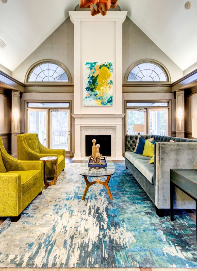 Lobby area with a fireplace and a large rug at Marquis on Edwards Mill in Raleigh, North Carolina