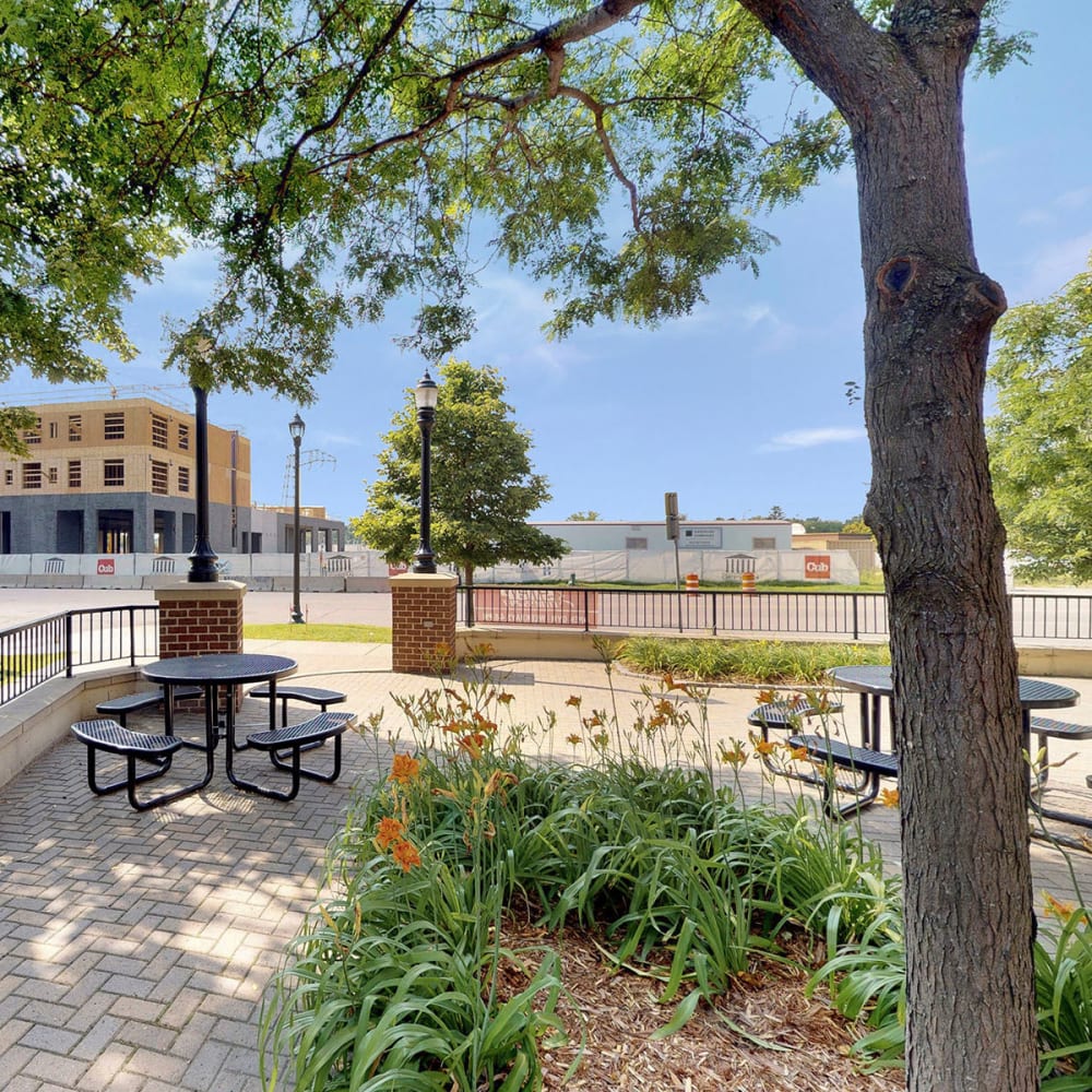 Park-like courtyard shaded by mature trees at Oaks Hiawatha Station in Minneapolis, Minnesota