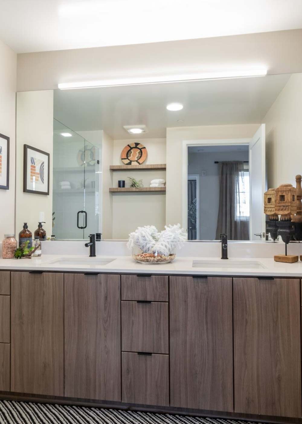 Bathroom with huge frameless vanity mirror  at Prado West in Dana Point, California