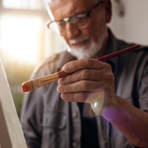 Resident painting a picture at Oxford Springs Tulsa Memory Care in Tulsa, Oklahoma