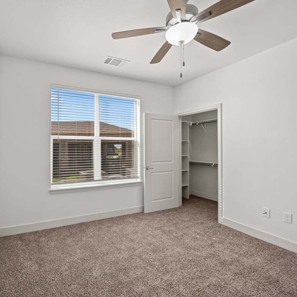 Bedroom with plush carpeting at Brook Hollow in Wichita Falls, Texas