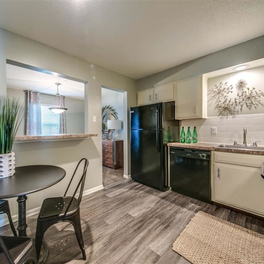 Updated kitchen with modern appliances at London House Apartments in Lenexa, Kansas