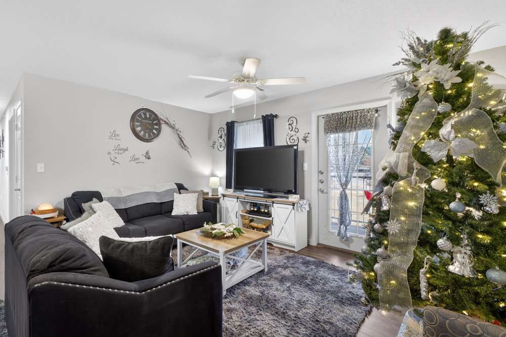 Charming living room adorned with festive decor and cozy furnishings at Lakewood Crossing in Granbury, Texas.