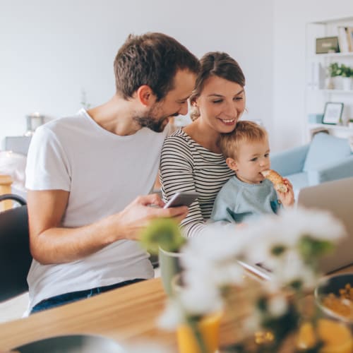 A family sitting at a table in a home at Silver Strand I in Coronado, California