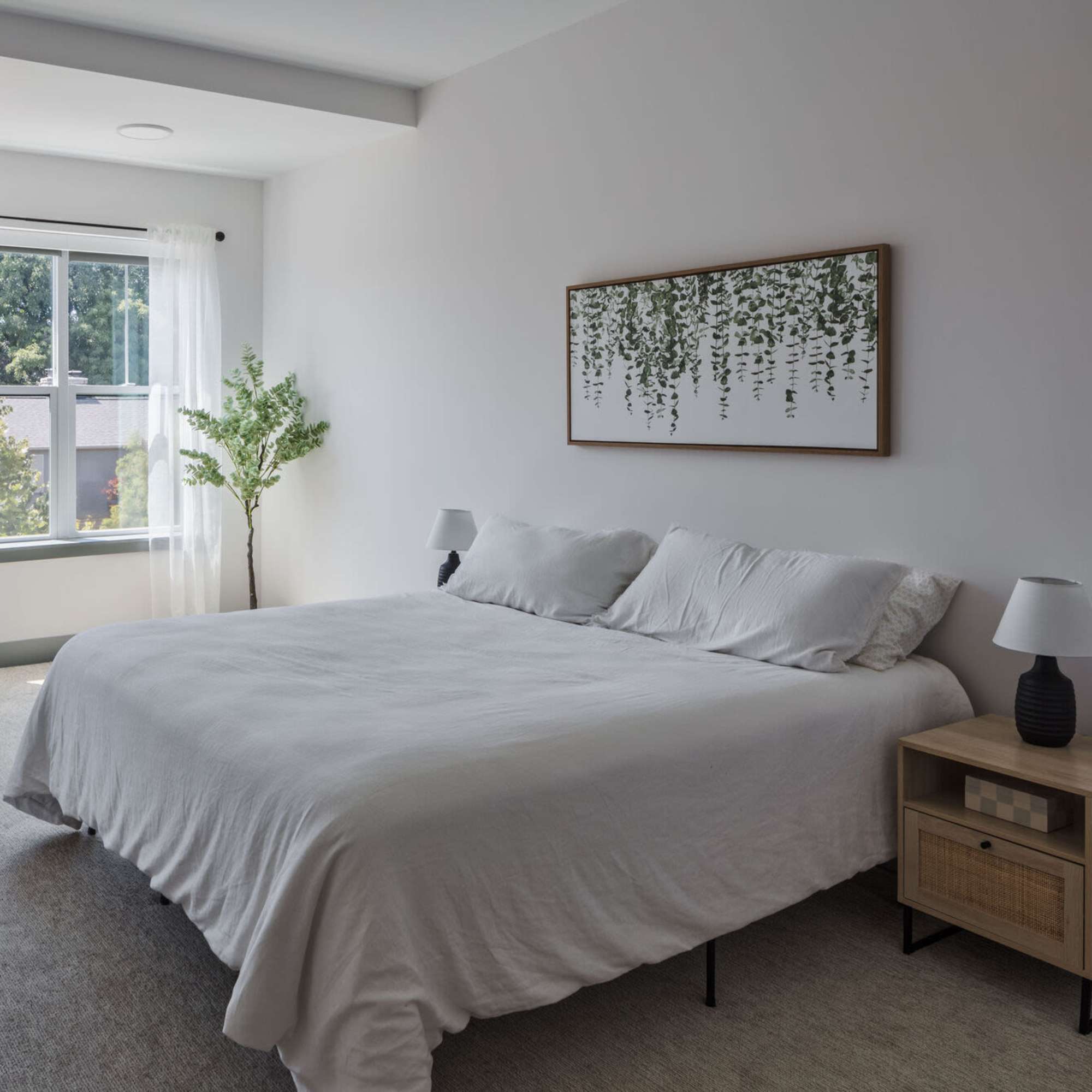 A comfy bed in a bedroom of the apartment home at Westmont at The Lane in Columbus, Ohio