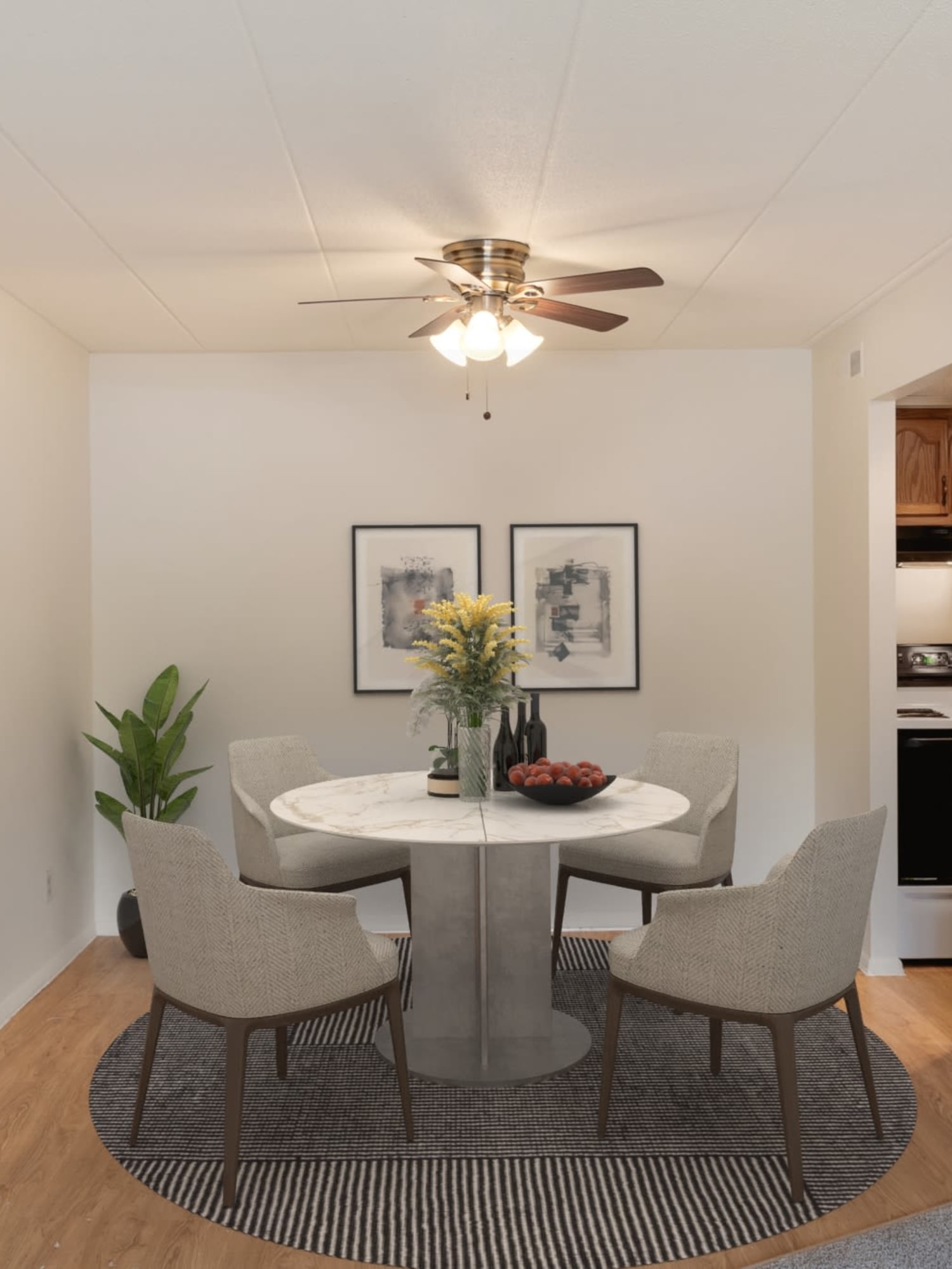 A dining room with a ceiling fan at Vantage Pointe West Apartments in Cincinnati, Ohio