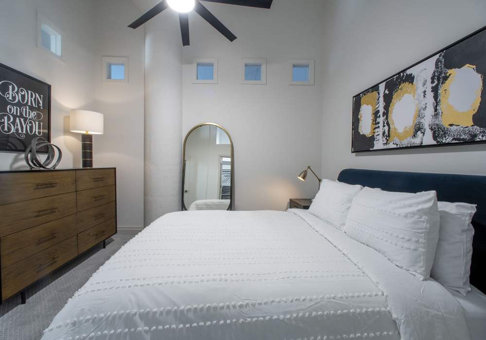 Modern bedroom with stylish decor and lighting at American Can Apartments in New Orleans, Louisiana 
