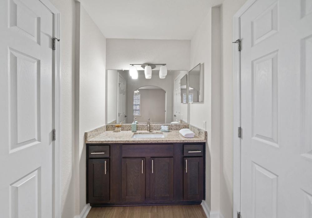 Bathroom with sink, granite countertop and storage spaces at Reserve at Northshore in Lynn Haven, Florida