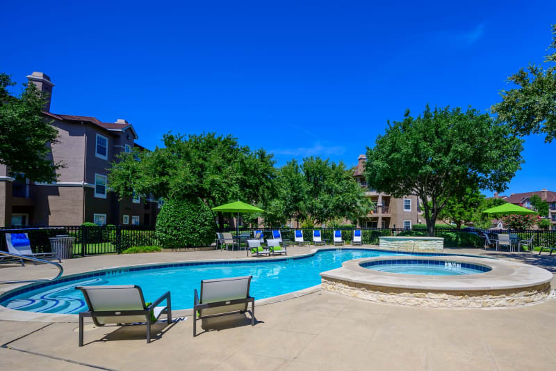 Resort style pool with lounge chairs at The View at Lakeside in Lewisville, Texas