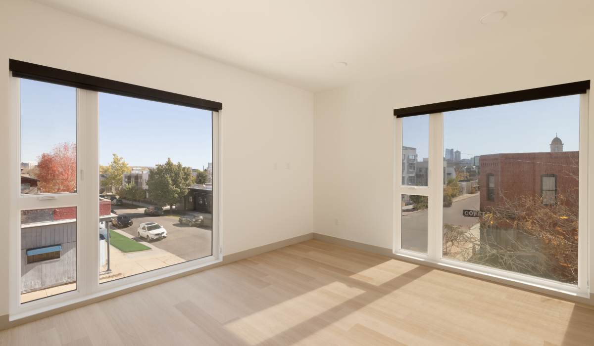 Spacious living room with large windows at Accent LoHi in Denver, Colorado