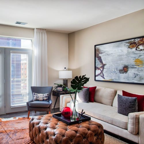 Model living room with doors to balcony at Circa Apartments in Indianapolis, Indiana