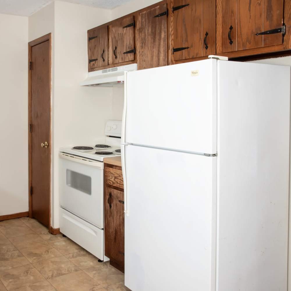 Kitchen with refrigerator and range at Bass Lake Crossing in New Hope, Minnesota
