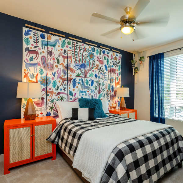 Bed with checkered bedspread and matching end tables at Sandy Lofts in Portland, Oregon