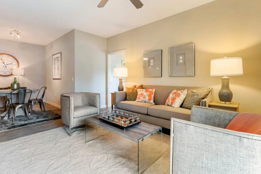 Open dining area and living room with wood-style floors and a ceiling fan at The Village at Apison Pike in Ooltewah, Tennessee