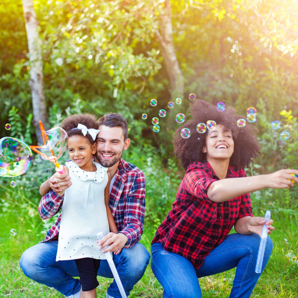 Family having fun outdoors at Avalon Villas neighborhood; schedule your tour today!