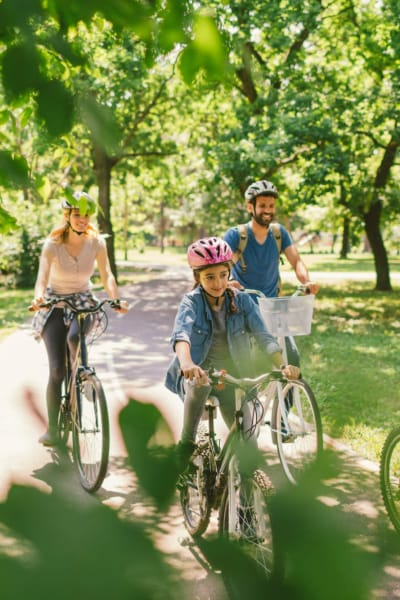 A family rides their bikes in a park near Tamarron, Phoenix, Arizona