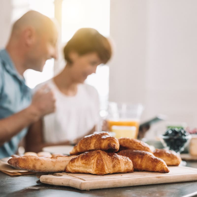 A couple enjoy breakfast pastries in their kitchen at Alate Old Town, Alexandria, Virginia